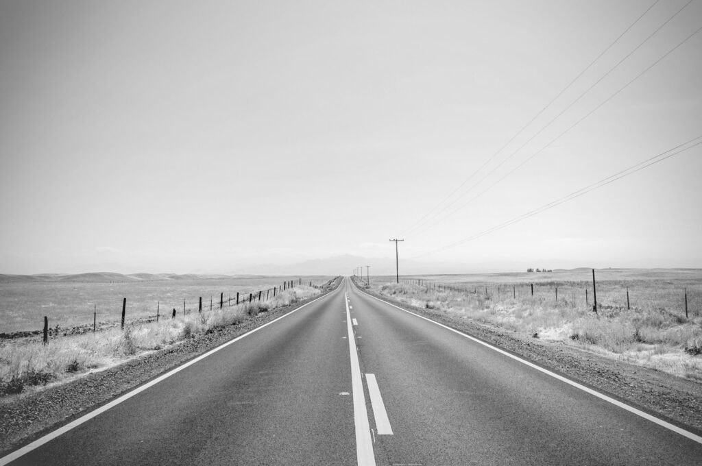 Minimalist contact footer for Gerhard Hofer Carbon Consulting, set against an open landscape. The text reads "Let's build your decarbonization roadmap" and shares project contact information.